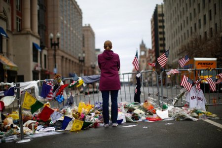 A woman visited the memorial to the bombing victims on Boylston Street, after Boston Marathon bombings; photo by Eric Thayer, published in the New York Times, April 20, 2013